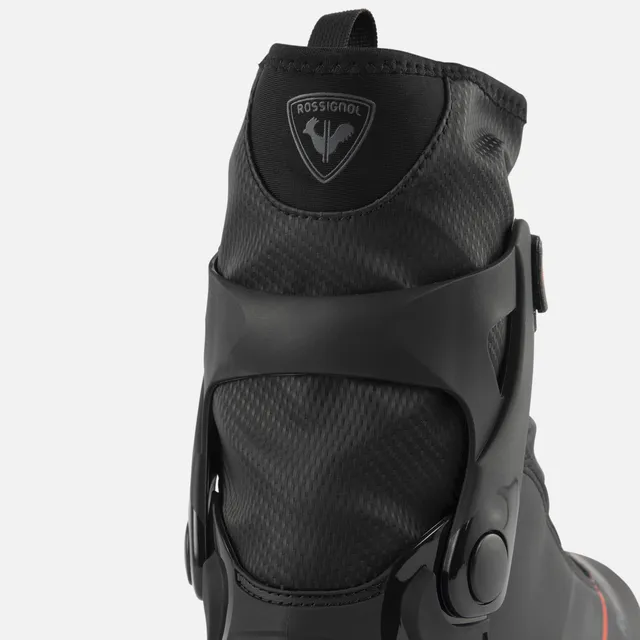 Nahaufnahme der Rückseite eines schwarzen ROSSIGNOL X-6 SC Skischuhs mit strukturiertem Material, dem Rossignol-Logo im oberen Bereich und einer stabilen schwarzen Kunststoffhalterung mit sichtbaren Scharnieren - erhältlich bei Mr. Bike Lichtenfels.